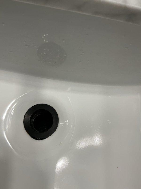 Returned to address ongoing leak issue following previous day's repair attempt. Inspected bathtub faucet assembly and drain components, including oil-rubbed bronze spout and fixtures mounted on marble deck. Identified persistent leak source, made necessary adjustments to faucet connections and verified proper sealing of all plumbing connections to resolve water leakage.