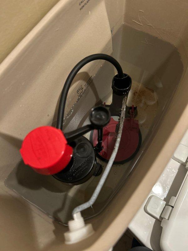 Responded to service call for toilet not filling properly. Inspected toilet tank components and identified issue with fill valve assembly. Verified flush valve, flapper mechanism, and overflow tube were functioning correctly. Adjusted fill valve with red cap to restore proper water level and fill cycle. Confirmed water supply line and shut-off valve connections were secure with no leaks present. Tested toilet operation through multiple flush cycles to ensure tank fills to appropriate level and all components function as designed.