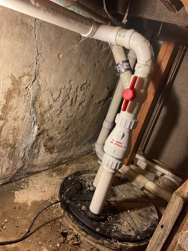 Responded to service call for non-functional ejector pump system in basement utility area. Upon inspection, confirmed existing ejector pump had failed and required complete replacement. Assessed the current installation including white PVC discharge piping assembly with shut-off valve, multiple elbow connections, and floor penetration boot. Provided detailed estimate for ejector pump replacement including removal of failed unit, installation of new ejector pump with appropriate basin, reconnection of existing PVC discharge piping system, and verification of proper operation upon completion.