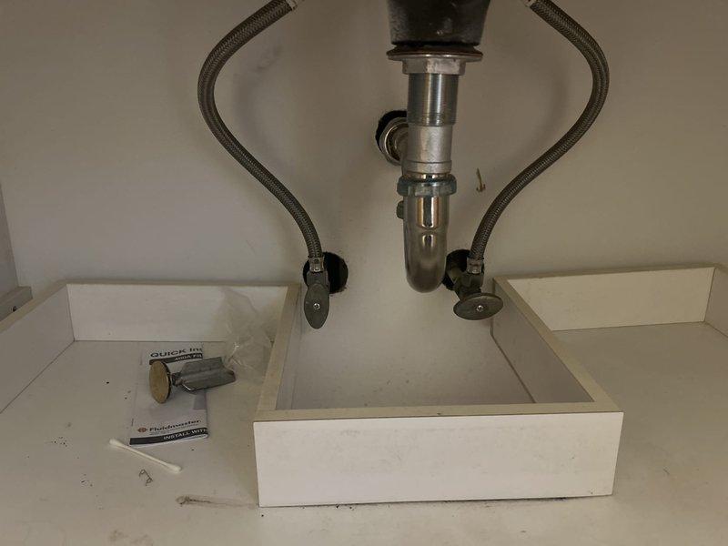 Conducted site assessment for bathroom remodel plumbing requirements, documenting existing under-sink drain assembly with P-trap configuration and dual braided stainless steel supply lines with shut-off valves, as well as toilet area water supply connections. Remodel quote to be prepared based on documented conditions and customer requirements.