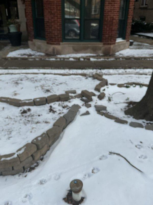 Conducted site assessment for flood control installation at a nine-unit commercial condominium building constructed directly adjacent to the sidewalk with no front yard available for traditional check valve placement. Evaluated the parkway area as an alternative installation location for backwater valve system, documenting existing conditions including utility access points, landscaping features, and building foundation proximity. Photographed site conditions to support permit application process for installing flood control device in the public right-of-way, as this represents the only viable option for protecting the property from sewer backup due to the building's setback constraints.