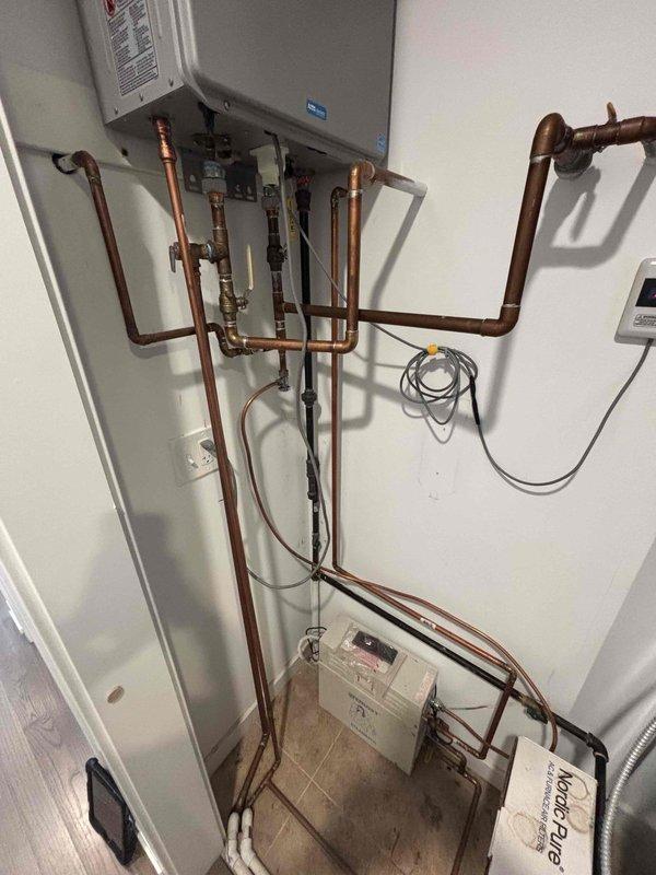 Responded to service call for Noritz tankless water heater with flashing error light and intermittent hot water loss. Performed diagnostic inspection of unit and associated copper piping system. Identified fault code on control panel and assessed system operation. Verified proper gas supply, water flow, and venting configuration. Inspected all copper pipe connections, shut-off valves, and mounting hardware for leaks or defects. Unit operational at time of service completion with error code cleared.