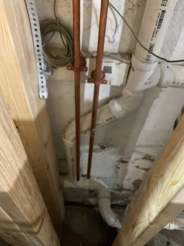 Returned to commercial property to complete remaining plumbing fixture installation work in basement utility area. Completed copper pipe routing through floor joists and structural framing, secured all supply lines with appropriate brackets and strapping per code requirements, and coordinated final connections with existing HVAC ductwork and electrical systems in the exposed mechanical space.