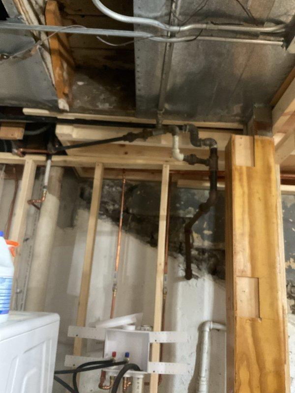 Returned to commercial property to complete remaining plumbing fixture installation work in basement utility area. Completed copper pipe routing through floor joists and structural framing, secured all supply lines with appropriate brackets and strapping per code requirements, and coordinated final connections with existing HVAC ductwork and electrical systems in the exposed mechanical space.