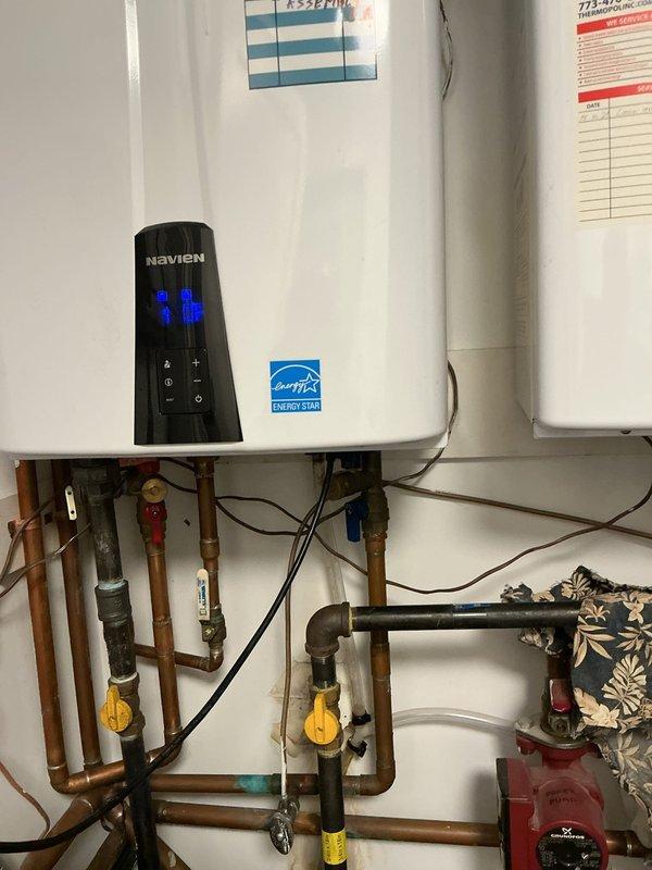 Removed and hauled away the failed condensate trap assembly from the domestic Navien tankless water heater. Installed a new factory-supplied condensate trap assembly to restore proper drainage and prevent potential water damage. System tested and verified operational upon completion.