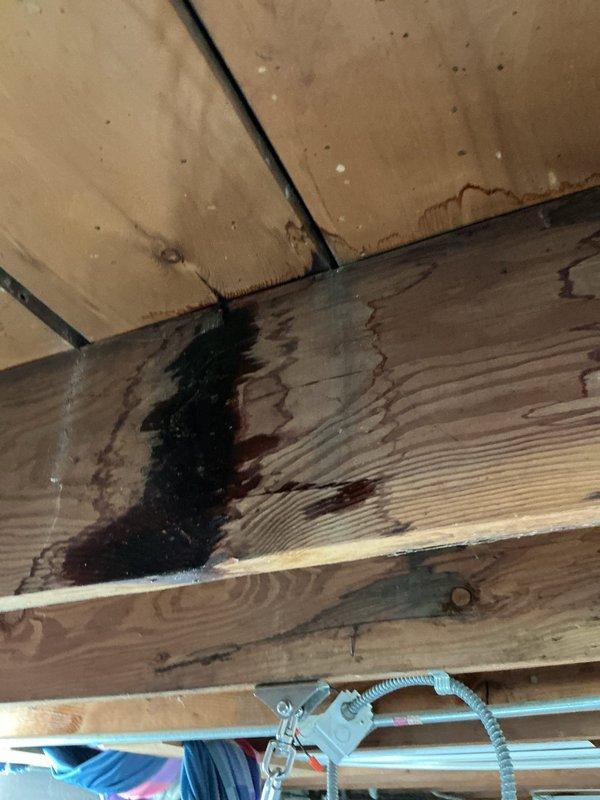 Responded to service call for potential radiator leak investigation. Conducted thorough inspection of basement utility area and exposed ceiling structure. Located active water leak source at wooden floor joist showing significant moisture damage and dark staining consistent with ongoing water infiltration. Identified compromised area above plumbing supply lines where water had been tracking down structural beam. Documented leak location with photographic evidence showing water-damaged joists, exposed PVC drain lines, copper supply lines, and HVAC ductwork in affected area. Traced leak pattern to determine origin point and extent of moisture penetration in ceiling structure. Provided property owner with findings and recommendations for necessary repairs to resolve active leak condition.