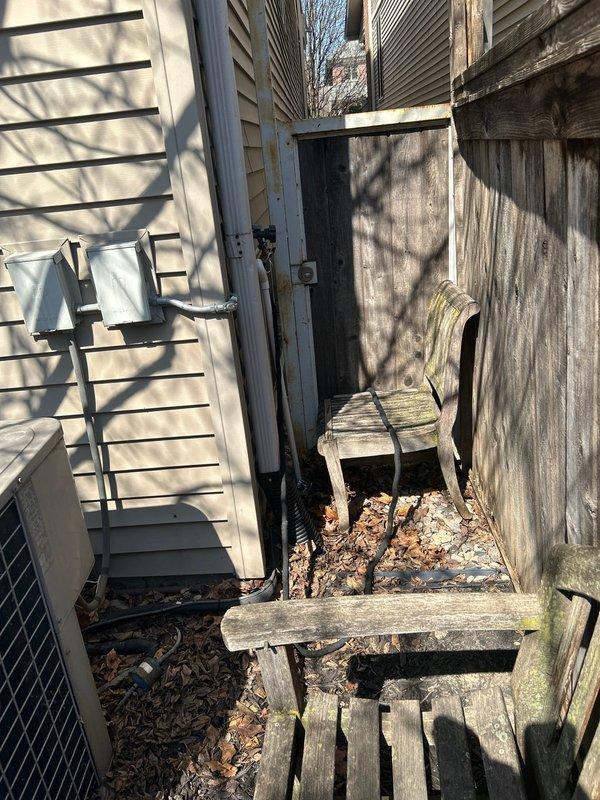 Responded to service call for water leak originating from copper supply lines above water heater. Upon inspection, identified active leak at copper piping connections near top of water heater unit where brass fittings interface with copper supply lines. Examined complete plumbing system in utility room including water heater installation, pressure tank, shut-off valves, and associated copper, PVC, and black iron piping. Documented conditions of all plumbing components, connections, and potential leak sources throughout the system. Inspected exterior access areas and perimeter of structure for additional plumbing concerns as requested.