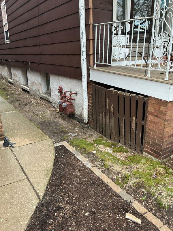 Replaced defective gas line shut-off valve to facilitate dryer installation at commercial property. The existing valve assembly servicing the dual gas meter installation showed signs of weathering and required replacement to ensure proper gas flow control and safe appliance connection. Work completed at exterior gas meter location mounted on building foundation.