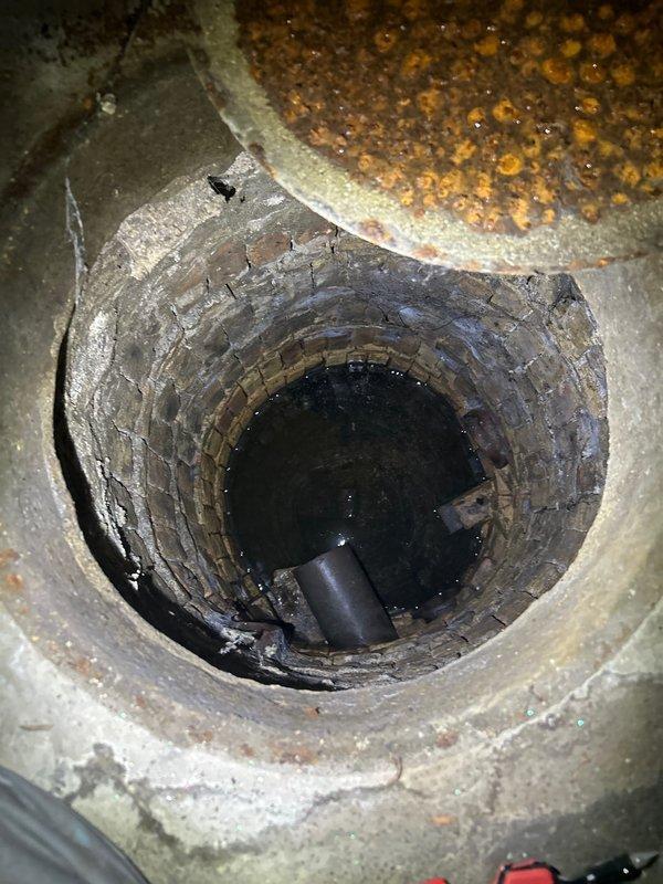 Responded to customer complaint of sewage odors and gurgling sounds from kitchen sink when ejector pump cycles. Upon inspection, identified issues with ejector pit system including deteriorated components and improper venting causing sewer gases to escape through plumbing fixtures. Documented existing conditions of ejector pump installation, associated piping network, and pit interior showing standing water and signs of system age. Provided detailed estimate for waste pump system repairs to resolve odor intrusion and restore proper operation.