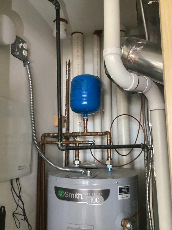 Completed plumbing estimate for new water line installation from 4th floor to rooftop mechanical area. Assessed existing utility room infrastructure including vertical PVC piping runs, AO Smith water heater with expansion tank, copper manifold system, and thermal insulation requirements. Documented routing path through multiple floor levels and mechanical room specifications for supply line installation.