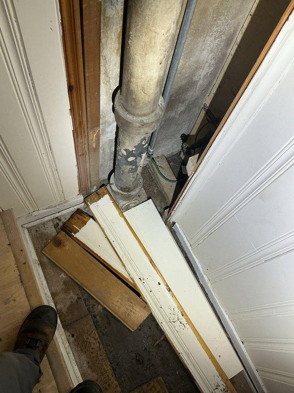 Completed residential drain and sewer estimate for deteriorated basement plumbing system. Assessment revealed aged vertical drainage pipes with significant discoloration and buildup, compromised floor surfaces with extensive moisture damage around drain fixture, and exposed utilities requiring attention. Documented existing conditions through photography showing corroded pipe infrastructure, degraded concrete flooring with substrate exposure, and unfinished utility space with visible water intrusion issues requiring comprehensive drain and sewer system evaluation for repair recommendations.
