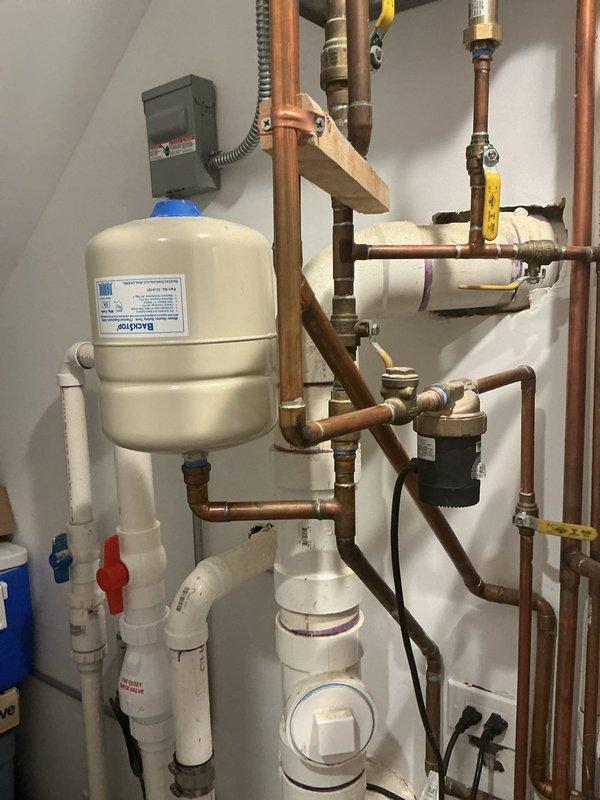 Responded to a water leak issue caused by a failing expansion tank on the water heater system. Upon inspection, confirmed the expansion tank had been leaking for approximately one week and required replacement. Successfully removed the defective expansion tank and installed a new replacement unit from available stock inventory. Verified all connections were properly sealed, tested the system for leaks, and confirmed proper operation of the water heater and associated plumbing components. The new expansion tank was securely mounted and integrated with the existing copper piping and valve assembly to restore full system functionality.