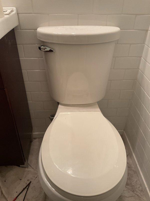Responded to service call for reported toilet seal leak in occupied rental unit. Upon arrival, performed comprehensive inspection of both toilets in the unit to assess functionality and identify source of leakage. Examined wax ring seals, water supply connections, tank-to-bowl gaskets, and floor flange conditions on both fixtures. Verified proper operation of flush mechanisms, fill valves, and flapper assemblies. Inspected surrounding floor tiles for water damage or moisture intrusion. Both toilets were found to be standard two-piece white porcelain units with chrome flush levers and supply lines in proper working condition at time of inspection.