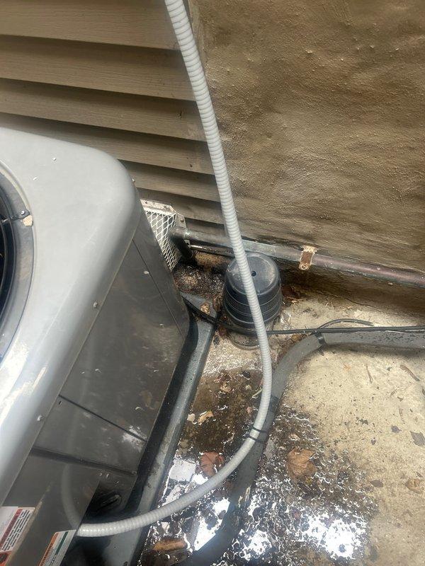 Responded to service call for reported leaking pipe requiring replacement. Upon arrival, conducted thorough inspection of exterior plumbing system adjacent to HVAC unit installation. Located source of leak at corroded copper pipe fitting showing advanced deterioration with significant oxidation, patina buildup, and moisture damage. 

Assessed copper piping assembly displaying mottled brown and green corrosion typical of prolonged water exposure and age-related degradation. Documented existing conditions through photographic evidence showing compromised pipe integrity at connection point. Evaluated surrounding plumbing infrastructure including conduit routing, drainage lines, and mounting configuration on concrete pad foundation.

Prepared comprehensive estimate for copper pipe replacement including affected fittings and connections. Estimate covers removal of deteriorated section, installation of new copper piping with proper fittings, and restoration of water-tight seal to eliminate a