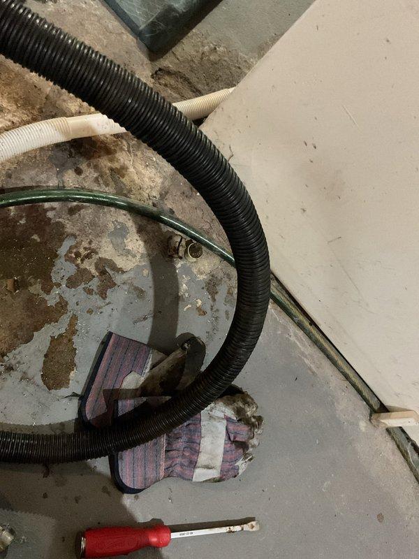 Responded to sewage backup in basement caused by heavy rainfall overwhelming the drainage system. Upon arrival, found sewage had discharged from floor drain onto concrete basement floor. Utilized wet/dry vacuum equipment to extract standing water and sewage from affected area. Inspected floor drain assembly and identified heavily corroded drain cover with significant rust deterioration affecting proper drainage function. Cleared debris and buildup from drain opening to restore flow capacity and prevent future backup issues during rain events.