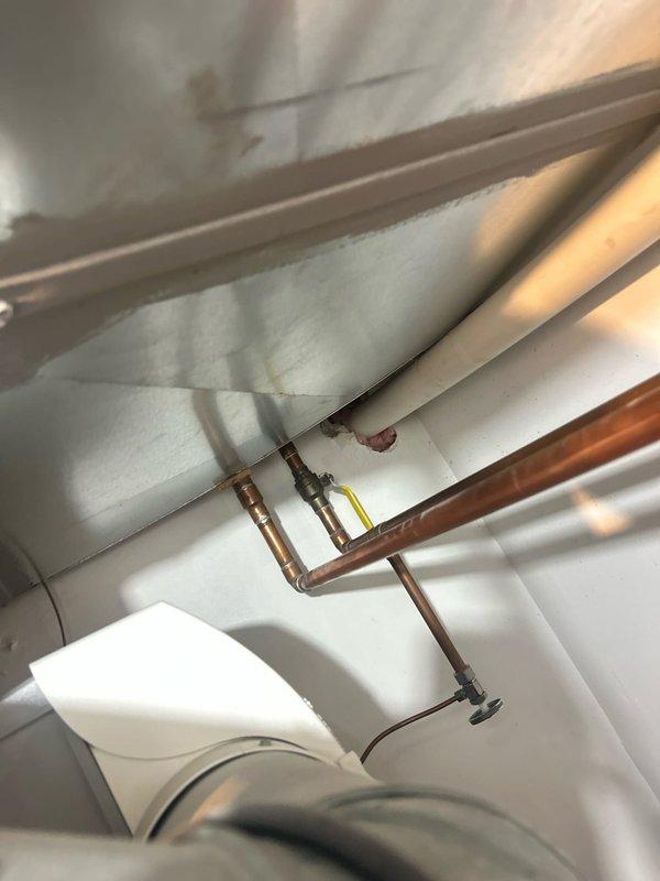 Completed plumbing estimate for water heater replacement in mechanical room. Assessed existing water heater installation, surrounding copper supply lines, galvanized ductwork connections, and associated shut-off valves. Documented current configuration including pipe routing, electrical connections, and clearance requirements for future water heater installation.