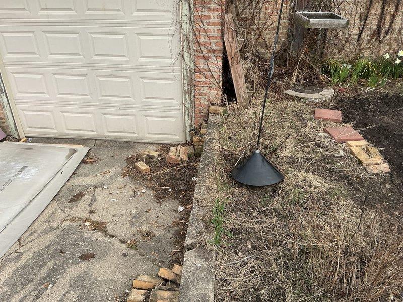 Completed on-site evaluation for check valve installation on main sewer line at a 90-year-old residential property. Assessed exterior access points along the side of the structure, examining the main sewer line routing and potential installation locations. Documented existing conditions including deteriorated landscaping materials, displaced pavers, and overgrown vegetation affecting access to utility connections. Identified electrical meter location and existing plumbing infrastructure including downspout and drainage systems that may impact installation approach. Evaluated soil conditions and ground-level access for excavation requirements. Photographed site conditions to support estimate preparation for backflow prevention device installation on aging residential sewer system.