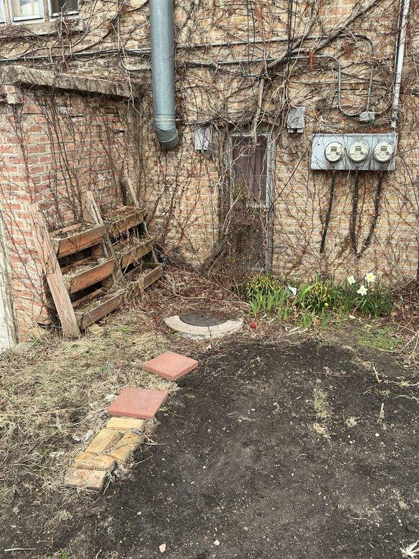 Completed on-site evaluation for check valve installation on main sewer line at a 90-year-old residential property. Assessed exterior access points along the side of the structure, examining the main sewer line routing and potential installation locations. Documented existing conditions including deteriorated landscaping materials, displaced pavers, and overgrown vegetation affecting access to utility connections. Identified electrical meter location and existing plumbing infrastructure including downspout and drainage systems that may impact installation approach. Evaluated soil conditions and ground-level access for excavation requirements. Photographed site conditions to support estimate preparation for backflow prevention device installation on aging residential sewer system.