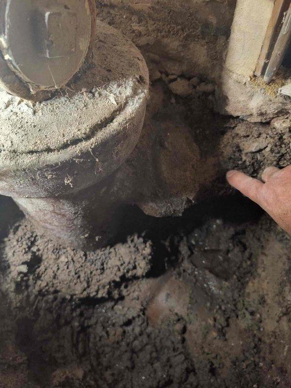 # Main Line Sewer Installation

Completed main line sewer installation requiring excavation work. Pre-excavation inspection revealed heavily accumulated dust, debris, and deteriorated soil conditions in the crawl space area surrounding existing plumbing infrastructure. Successfully excavated and prepared the work site, removing contaminated soil and clearing access to install new main line sewer components with proper drainage and structural support.