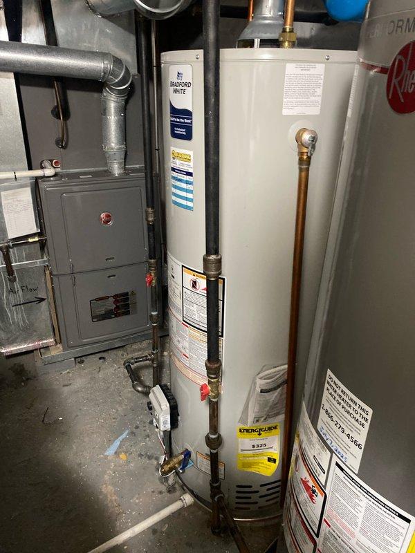 Responded to service call for reported gas leak on water heater and performed VIP maintenance on secondary unit. Upon arrival, conducted thorough inspection of both Bradford White water heaters in basement utility area. Utilized gas detection equipment to locate and assess reported leak on first unit, checking all gas line connections, control valve, and burner assembly connections. Performed complete VIP maintenance protocol on second water heater, including inspection of temperature and pressure relief valve, anode rod assessment, burner combustion analysis, gas line connections verification, and testing of all safety controls. Examined copper supply piping, brass shut-off valves, and compression fittings on both units for proper operation and signs of corrosion or wear. Verified proper venting and clearances around both water heaters in accordance with manufacturer specifications and local code requirements. Documented equipment conditions with photographic evidence showing installa