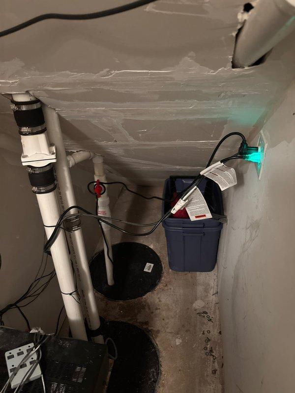 Responded to service call for non-functioning sump pump system in residential basement. Upon inspection, evaluated existing sump pump installation including basin, discharge piping, check valve assembly, and backup power components. Assessed PVC discharge line configuration with vertical routing and confirmed proper mounting hardware and electrical connections throughout the system. Documented current conditions of pump pit, cover assembly, and associated plumbing infrastructure. Provided comprehensive estimate for necessary repairs or replacement to restore full operational capacity to the water management system.