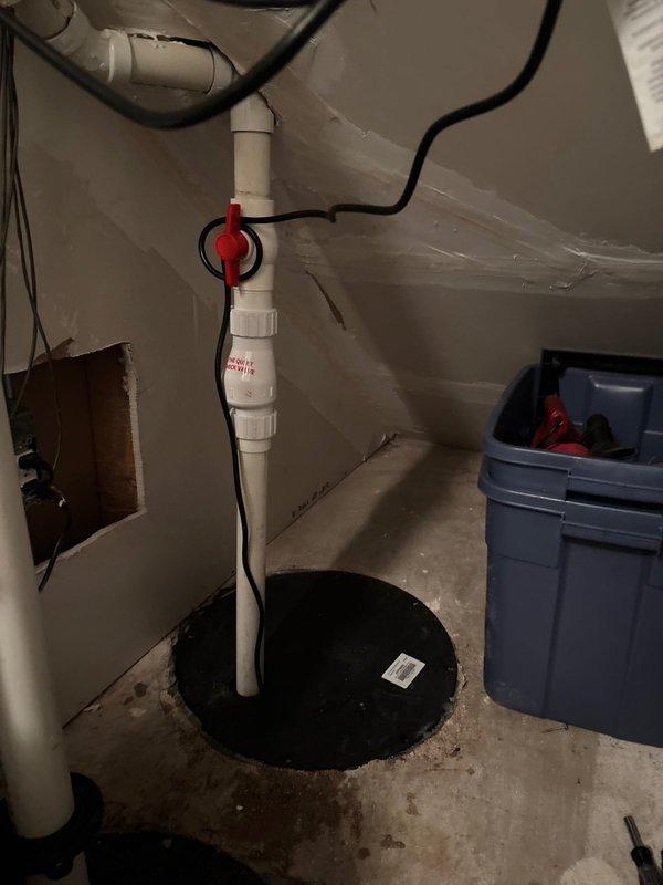 Responded to service call for non-functioning sump pump system in residential basement. Upon inspection, evaluated existing sump pump installation including basin, discharge piping, check valve assembly, and backup power components. Assessed PVC discharge line configuration with vertical routing and confirmed proper mounting hardware and electrical connections throughout the system. Documented current conditions of pump pit, cover assembly, and associated plumbing infrastructure. Provided comprehensive estimate for necessary repairs or replacement to restore full operational capacity to the water management system.