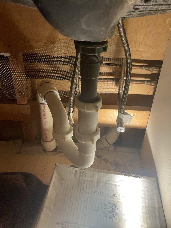Responded to a bathroom flooding issue caused by bathtub drainage backing up through the floor overflow drain. Upon inspection, identified a clogged drain line affecting both the bathtub and kitchen sink plumbing system. Cleared the obstruction in the drainage system, tested water flow through the bathtub drain and verified proper drainage through the P-trap assembly and garbage disposal connection under the kitchen sink. Confirmed all fixtures were draining properly with no further overflow issues.