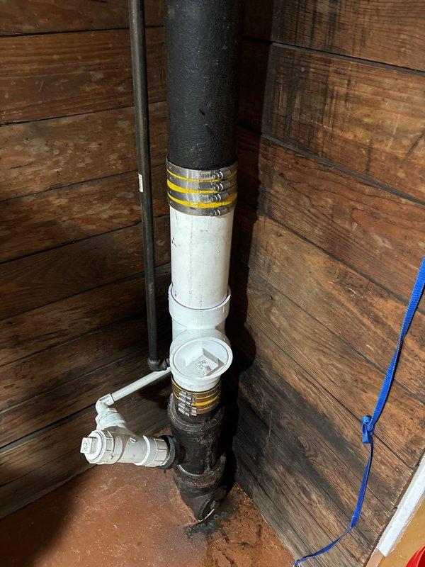 Completed tankless water heater installation including necessary piping modifications with 42", 24", and 48" nipples, 1"x3/4" tee, and 3/4"x1/2" reducers. Installed required gas and water supply connections in crawl space area, addressing existing pipe deterioration and ensuring proper venting through PVC drainage system. All connections secured with appropriate clamps and fittings, system tested and operational.