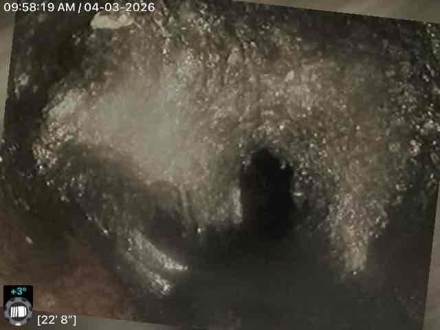 Performed video camera inspection of residential sewer line extending approximately 23 feet into the system. Documentation revealed significant accumulation of debris, mineral deposits, and particulate buildup coating the interior pipe walls throughout the inspected section. Captured detailed photographic evidence showing heavy scaling and material accumulation that could restrict flow capacity and require cleaning or further remediation.