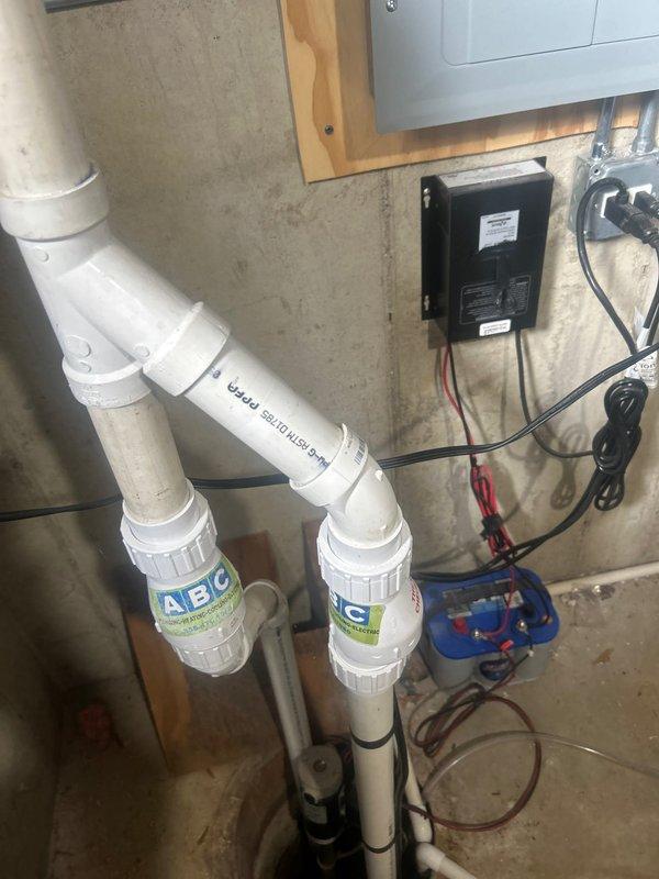 Responded to service call for sump pump producing abnormal noise over previous weeks. Performed comprehensive inspection of sump pump system and associated components including discharge piping, check valve, and electrical connections. Upon examination, pump remained operational with proper cycling function. Inspected motor housing, float switch mechanism, and impeller assembly for wear or debris accumulation. Evaluated water filtration system and pressure tank connections in proximity to sump installation. Documented current condition of all equipment with photographic evidence showing pump assembly, PVC discharge lines, and electrical control box. Verified proper operation and advised on system status, confirming no immediate component replacement required at this time.
