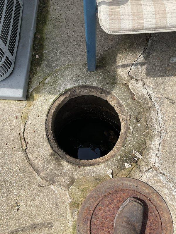 Completed same-day emergency rodding service to clear drainage obstruction. Accessed system through exterior catch basin and interior cleanout point to effectively remove blockage and restore proper water flow. Exterior catch basin showed significant deterioration with heavy rust staining on metal components and extensive concrete cracking around the access point, with standing water present prior to service. Successfully cleared the line using professional rodding equipment, working from both access points to ensure complete removal of obstruction. System tested and confirmed to be draining properly upon completion of service.