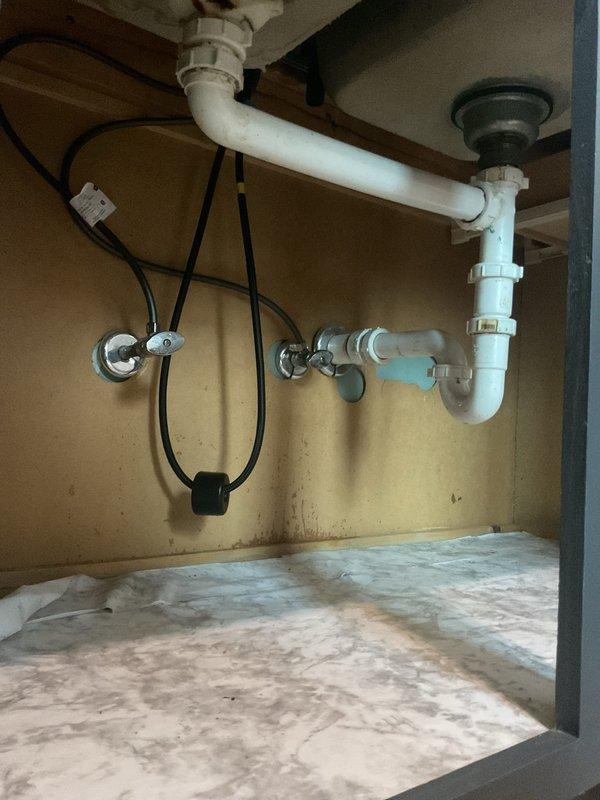 Installed customer-supplied chrome single-handle kitchen faucet on double-basin stainless steel sink. Replaced faulty gasket and addressed low water pressure issue on hot water supply line. Verified proper drainage connections, tested water flow and pressure on both hot and cold lines, and ensured all supply connections were secure with no leaks detected upon completion.