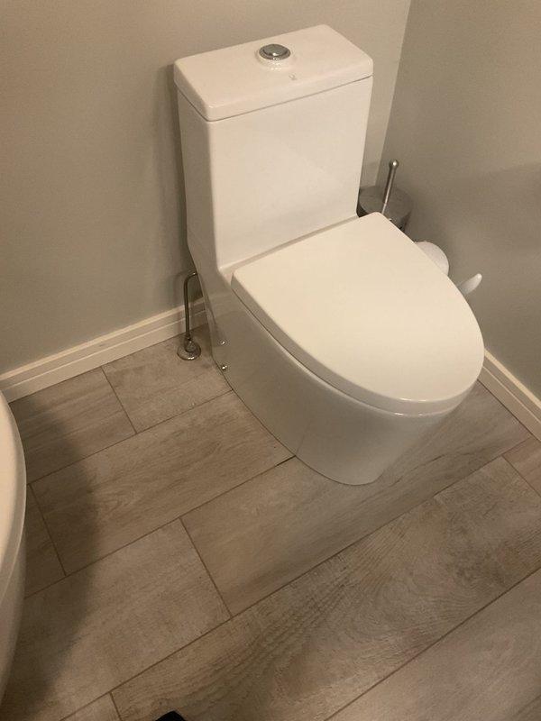 Removed and replaced two existing toilets with customer-supplied units in separate bathroom locations. Both installations involved disconnecting old fixtures, removing wax rings, inspecting and cleaning flange connections, and installing new two-piece toilets with dual-flush mechanisms. Ensured proper sealing with new wax rings, secured mounting bolts, connected water supply lines, and tested for leaks and proper flush operation. All fixtures are functioning correctly with no visible leaks detected.