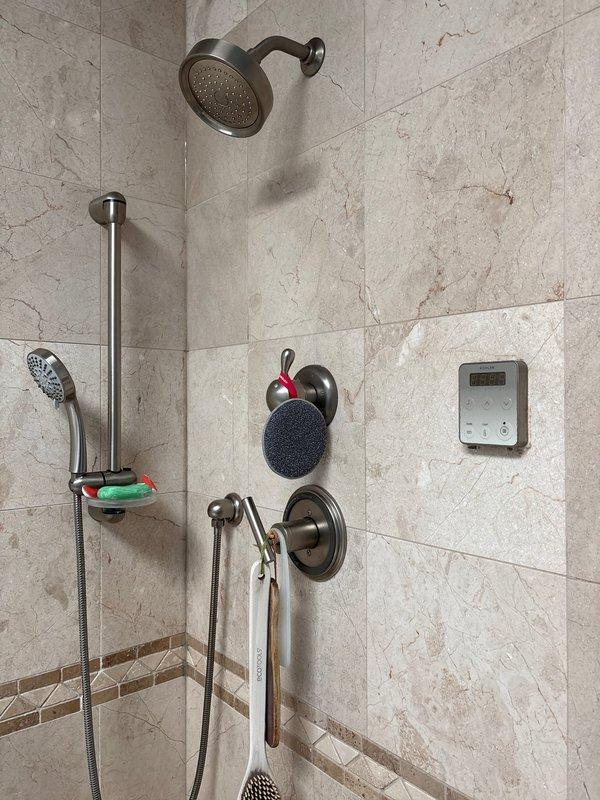 Responded to service call for shower with no hot water while other fixtures on same floor maintained proper hot water supply. Diagnosed and repaired malfunctioning shower valve cartridge that was restricting hot water flow to the showerhead while leaving tub spout unaffected. Additionally addressed leaking bathroom faucet by replacing worn valve stem washers and tightening packing nut to eliminate drip. Tested all fixtures post-repair to confirm proper hot and cold water delivery and verified no leaks present.