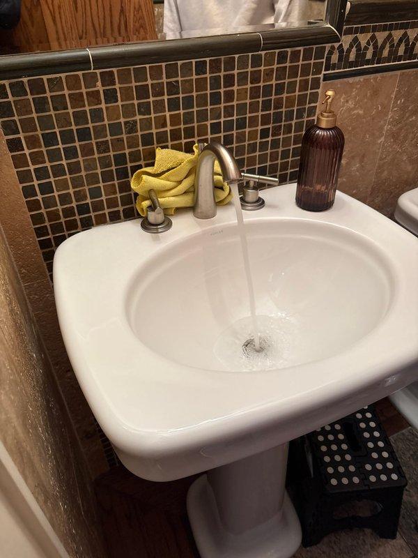 Responded to service call for shower with no hot water while other fixtures on same floor maintained proper hot water supply. Diagnosed and repaired malfunctioning shower valve cartridge that was restricting hot water flow to the showerhead while leaving tub spout unaffected. Additionally addressed leaking bathroom faucet by replacing worn valve stem washers and tightening packing nut to eliminate drip. Tested all fixtures post-repair to confirm proper hot and cold water delivery and verified no leaks present.