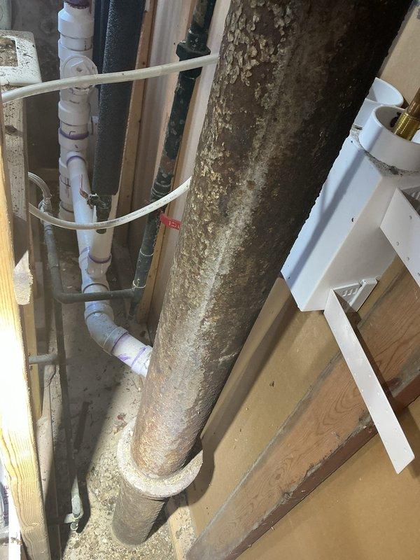 Responded to priority service call for a 130-year-old residential building experiencing sewer gas issues and drainage problems requiring catch basin repair. Upon inspection, discovered extensive mold and biological growth on main vertical drain stack in basement utility area, along with aging plumbing infrastructure combining original cast iron components with newer PVC additions. Conducted thorough assessment of exposed drain and sewer lines, documented deteriorated pipe conditions, identified potential sources of sewer gas infiltration at pipe joints and connections, and evaluated structural integrity of catch basin system to provide comprehensive estimate for necessary repairs and code-compliant replacements.