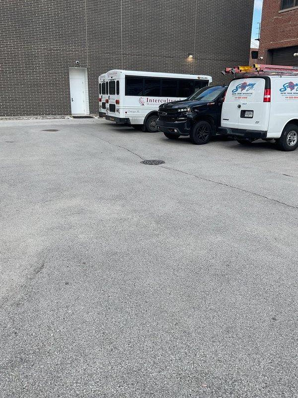 Responded to service call for sewer drain backup in parking lot area. Conducted on-site inspection of catch basin and drainage system, documented existing conditions of manhole cover and surrounding pavement surface showing signs of weathering and potential drainage issues. Performed visual assessment to determine scope of work needed for proper remediation of the backup condition.