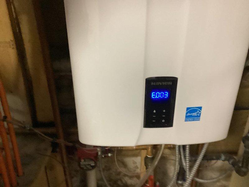 Responded to no hot water call and diagnosed Navien tankless water heater displaying error code E803. Inspected unit and associated plumbing connections including copper supply lines, flexible metallic hoses, and shut-off valves. Troubleshot igniter failure on system and resolved error code issue. Verified proper operation of unit, confirmed hot water restoration, and ensured all connections were secure with no leaks present.