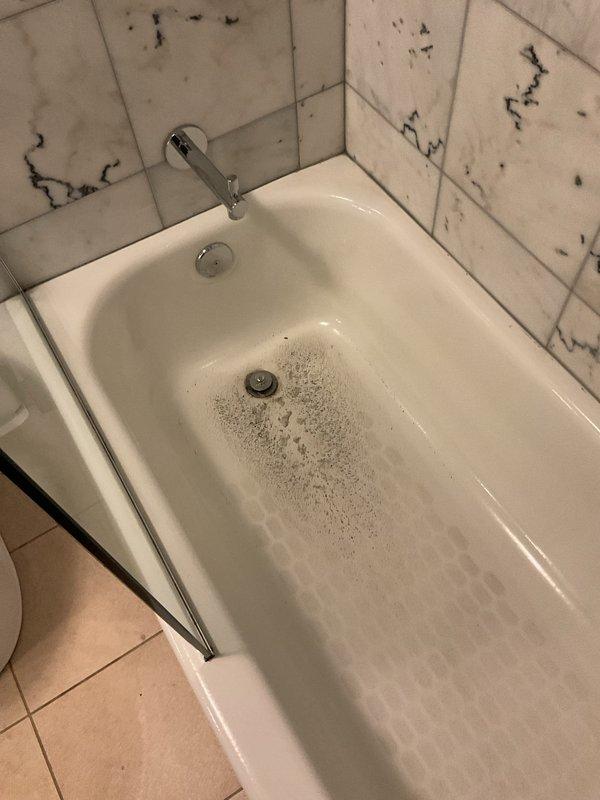 Responded to a basement bathroom experiencing drainage issues with bubbles and backflow occurring in both the toilet and bathtub. Upon inspection, identified a main drain line obstruction causing simultaneous backup in multiple fixtures. Cleared the blockage in the common waste line, restoring proper drainage and eliminating the gurgling and reverse flow conditions in both the toilet and tub drain systems.