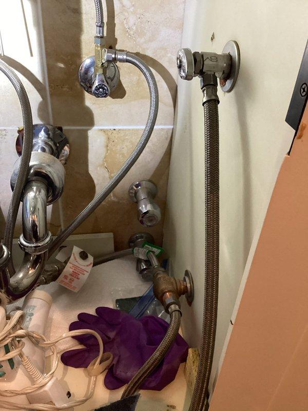 Responded to service call for malfunctioning shower components. Replaced leaking handheld showerhead hose with new braided stainless steel flex line and repaired broken shower diverter valve control knob to restore full functionality of the shower/tub fixture.
