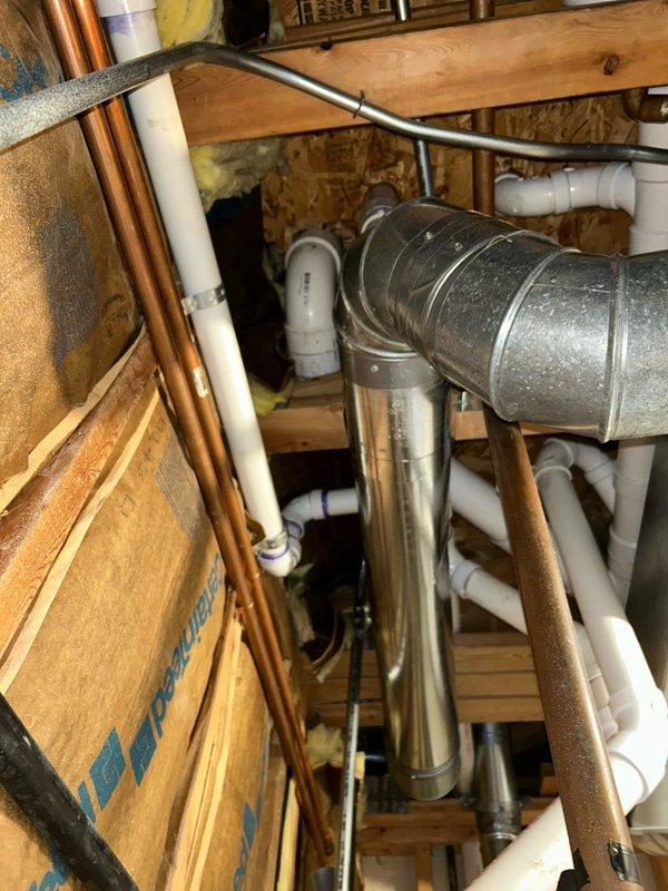 Accessed basement utility area and interior wall cavity to inspect and repair plumbing system components. Created access opening in drywall to reach concealed PVC drain and waste lines running vertically between wall studs. Evaluated copper supply lines, PVC drainage piping, and associated fittings for proper function and code compliance. Documented existing conditions of plumbing infrastructure, including pipe routing, connections, and integration with HVAC ductwork in unfinished basement space. Completed necessary repairs to restore proper drainage function and system integrity.