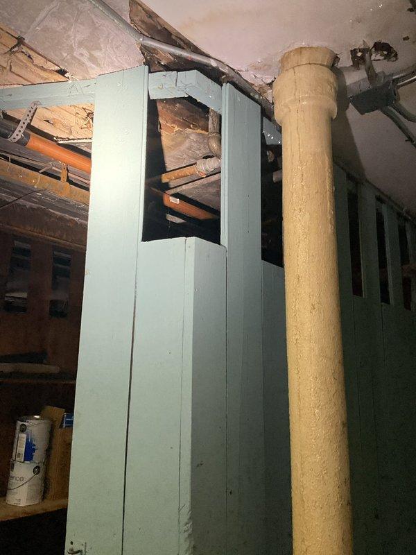 Responded to water leak investigation in basement area. Upon arrival, conducted thorough inspection of basement ceiling structure, exposed joists, and adjacent utility spaces to locate source of ongoing water infiltration. Examined wooden ceiling panels, brick wall junctions, and accessible crawl space areas where moisture damage was reported. Inspected exposed plumbing lines, ductwork penetrations, and support column areas for signs of active leaking or water staining. Documented findings with photographic evidence showing ceiling access points and basement mechanical room configuration to assist in determining leak origin and recommend appropriate repair solutions.