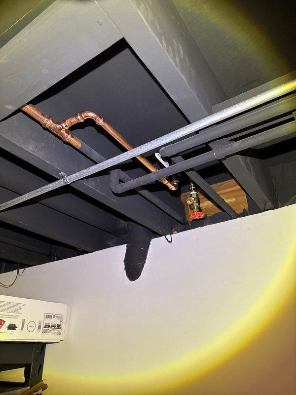 Installed new outdoor spigot system with copper supply line routed through masonry foundation using 1" core-drilled penetration. Connected piping to existing water supply in basement mechanical space with brass shutoff valve, properly insulated exposed lines with foam pipe insulation to prevent freezing, and secured all connections per code requirements.