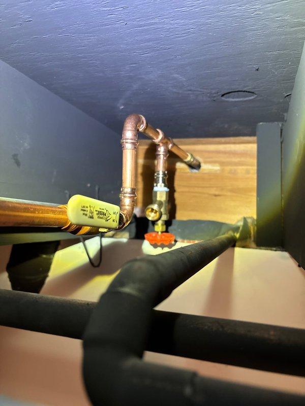 Installed new outdoor spigot system with copper supply line routed through masonry foundation using 1" core-drilled penetration. Connected piping to existing water supply in basement mechanical space with brass shutoff valve, properly insulated exposed lines with foam pipe insulation to prevent freezing, and secured all connections per code requirements.