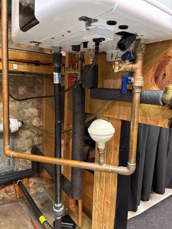 Completed warranty service by installing water treatment filtration system with polyphosphate media for scale prevention. Installed unit on basement wall near existing plumbing infrastructure and verified proper integration with under-sink copper supply lines and shut-off valves. System is operational and providing water conditioning to kitchen fixtures.