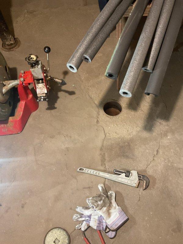 Responded to commercial building for main line rodding service. Upon arrival, accessed basement utility area where building's main sewer line was located. Performed mechanical rodding of the main drain line to clear blockage and restore proper flow throughout the building's plumbing system. Documented existing conditions including corroded cast iron drain piping with connections to PVC sections, noting the transition points and overall state of the drainage infrastructure. Work completed successfully with main line cleared and functioning properly.