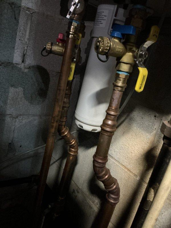 Performed descaling maintenance service on an A.O. Smith tankless water heater unit. Flushed the heat exchanger using descaling solution to remove mineral buildup and restore optimal heating efficiency. Inspected all copper supply lines, brass isolation valves, and plumbing connections for proper operation and verified system functionality upon completion.