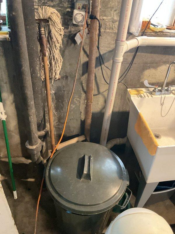 Performed comprehensive assessment of basement plumbing system including water heater installation, pressure tank, and associated piping infrastructure. Inspected vertical black pipe system with pressure relief valve assembly and verified proper operation of safety components. Evaluated copper and PVC pipe routing along concrete block walls for potential issues. Assessed condition of water heater or pressure tank connections and confirmed all mechanical fittings were secure and functioning correctly. Documented existing plumbing configuration and utility room conditions for repair planning and future service scheduling.