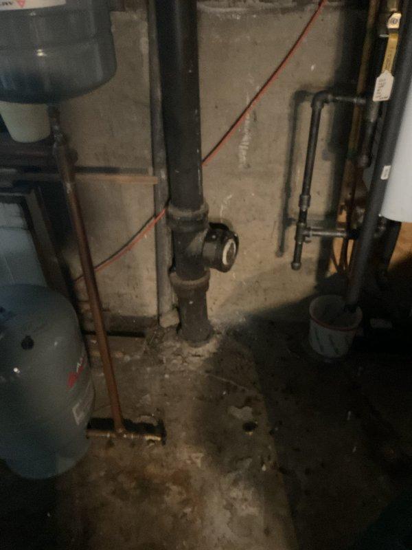 Performed comprehensive assessment of basement plumbing system including water heater installation, pressure tank, and associated piping infrastructure. Inspected vertical black pipe system with pressure relief valve assembly and verified proper operation of safety components. Evaluated copper and PVC pipe routing along concrete block walls for potential issues. Assessed condition of water heater or pressure tank connections and confirmed all mechanical fittings were secure and functioning correctly. Documented existing plumbing configuration and utility room conditions for repair planning and future service scheduling.