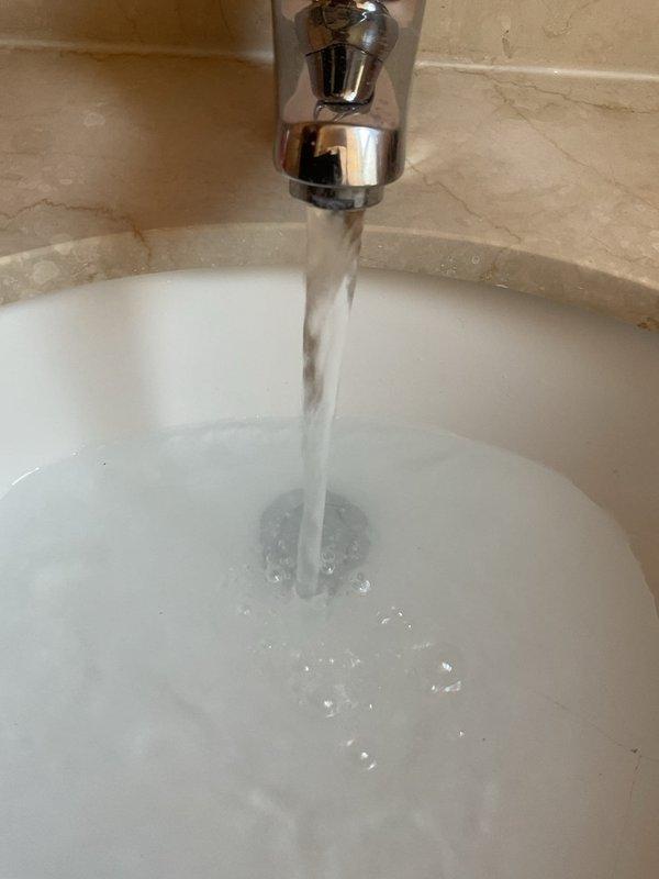 Responded to a service call for a bathroom sink experiencing slow drainage. Upon inspection, assessed the chrome-plated faucet assembly and P-trap configuration beneath the sink. Successfully cleared the obstruction from the drain line, restoring proper water flow and drainage function. Verified system operation and documented the completed work with photographs of the fixture and under-sink plumbing components.